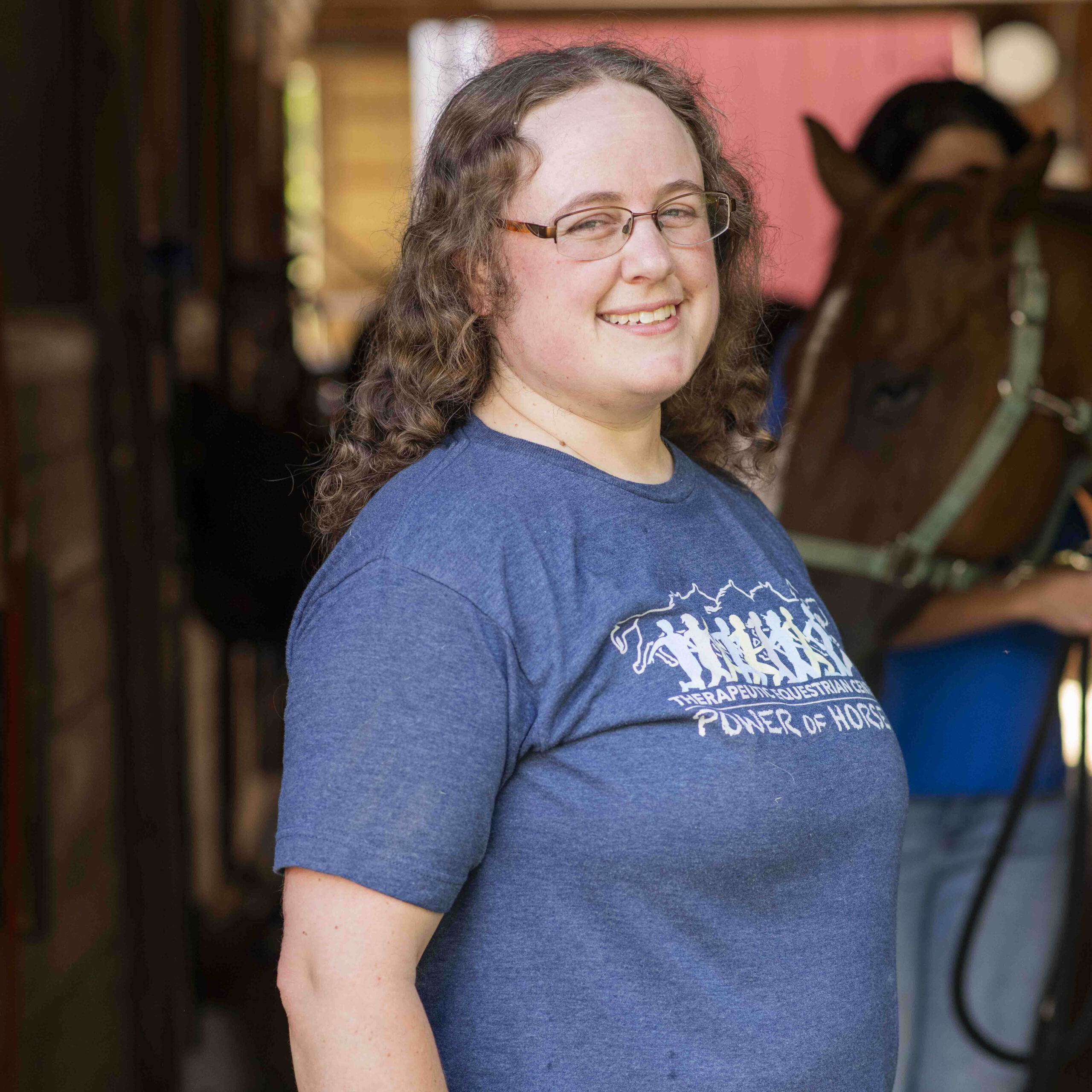 Lynn certified trainer by Professional Association of Therapeutic Horsemanship (PATH, formerly NARHA) in the barn at the Therapeutic Equestrian Center. 