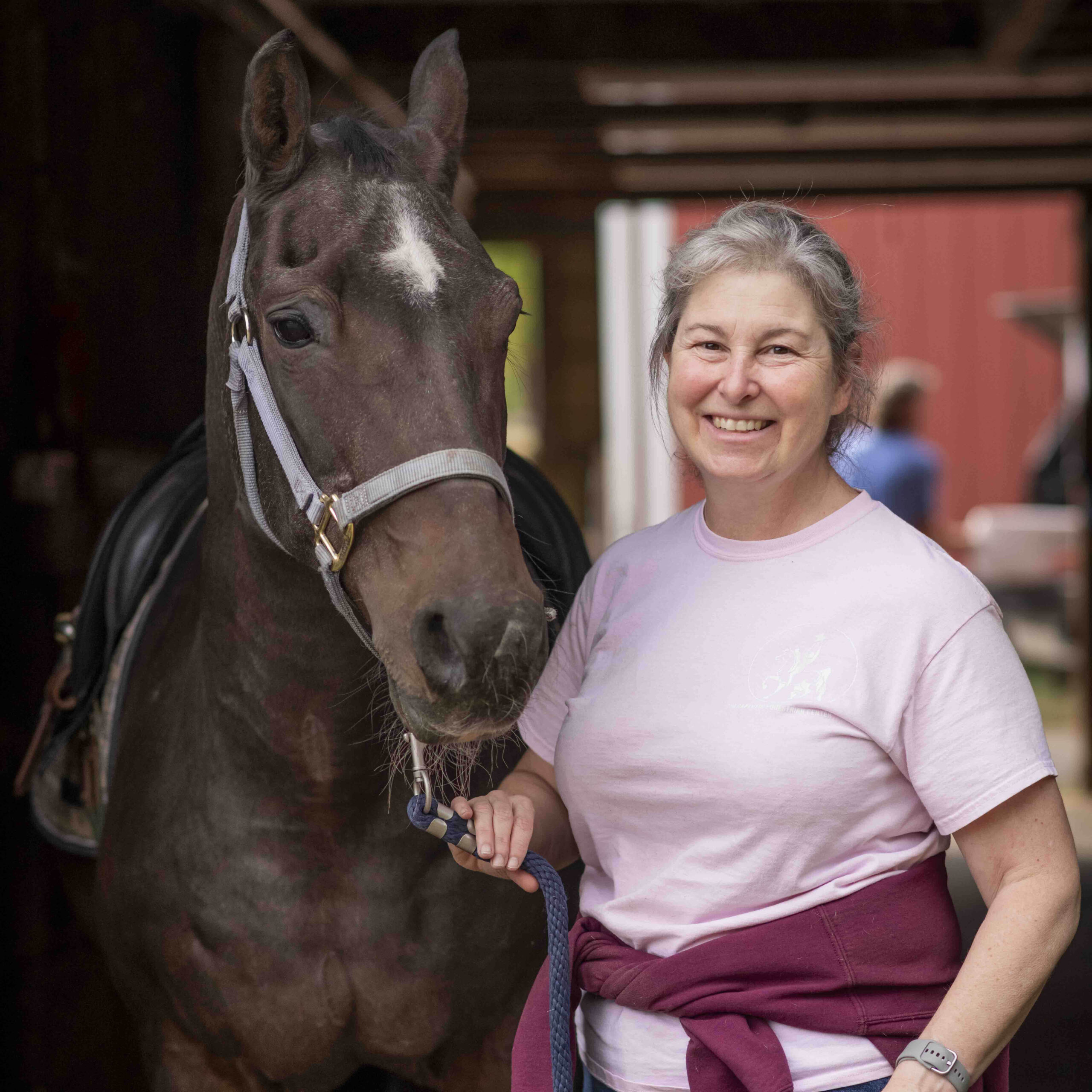 Nancy Karp Getchell certified trainer by Professional Association of Therapeutic Horsemanship (PATH, formerly NARHA) in the barn at the Therapeutic Equestrian Center. 